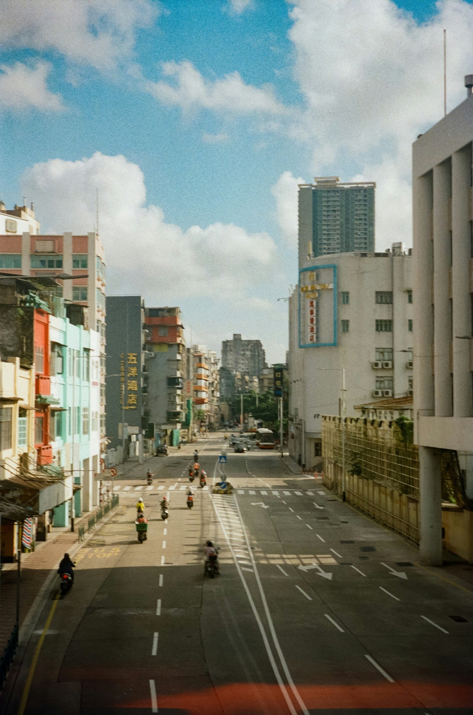 people walking on sidewalk near high rise buildings during daytime